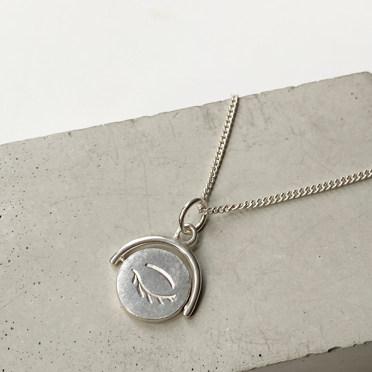 Winking Eye Spinning Pendant in Silver